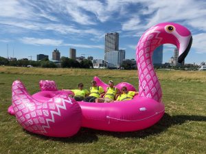 Volunteers take a break in a giant flamingo
